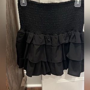 Black frilly skirt.